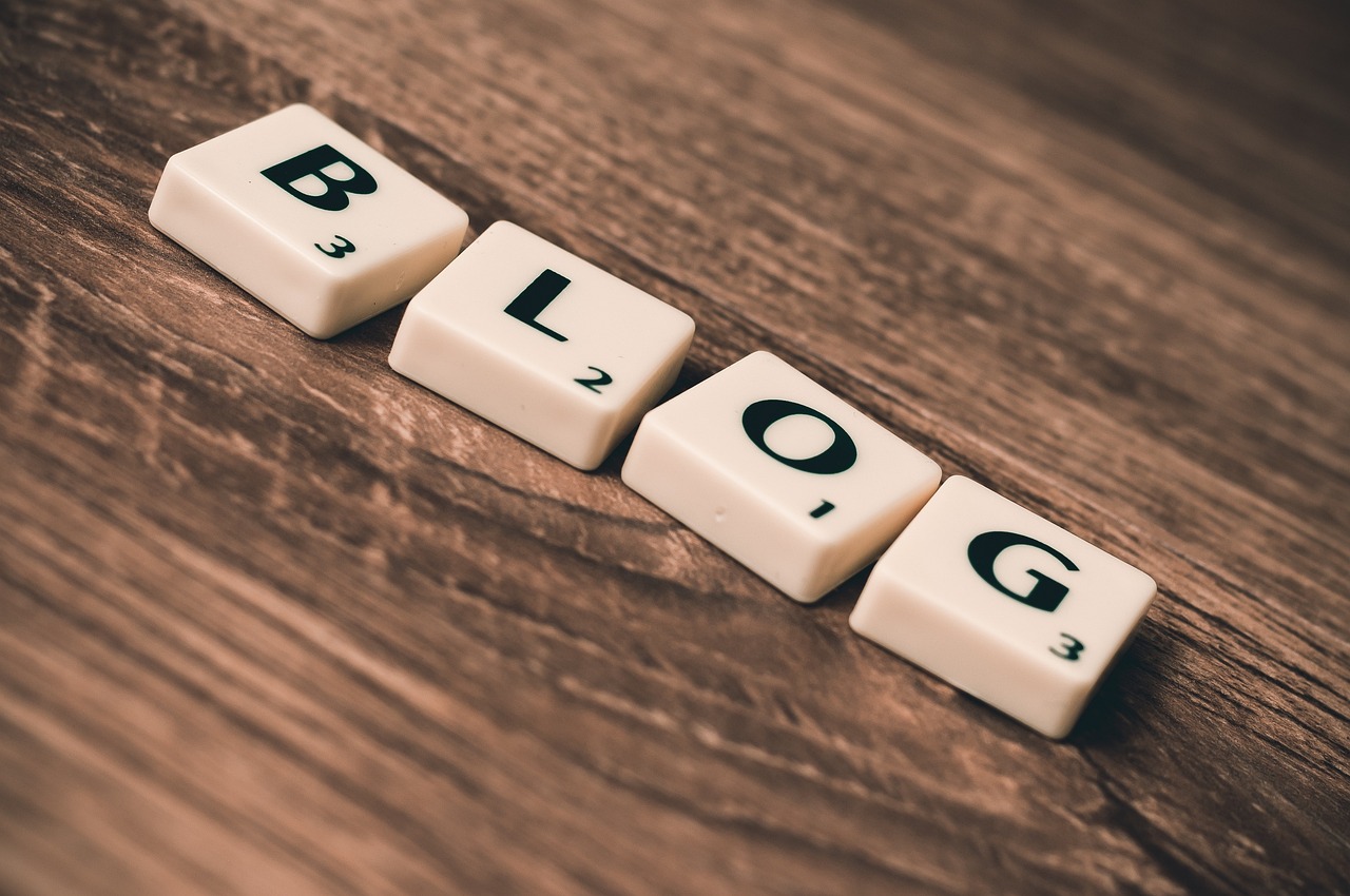 Letter tiles spelling the word blog on a wooden table